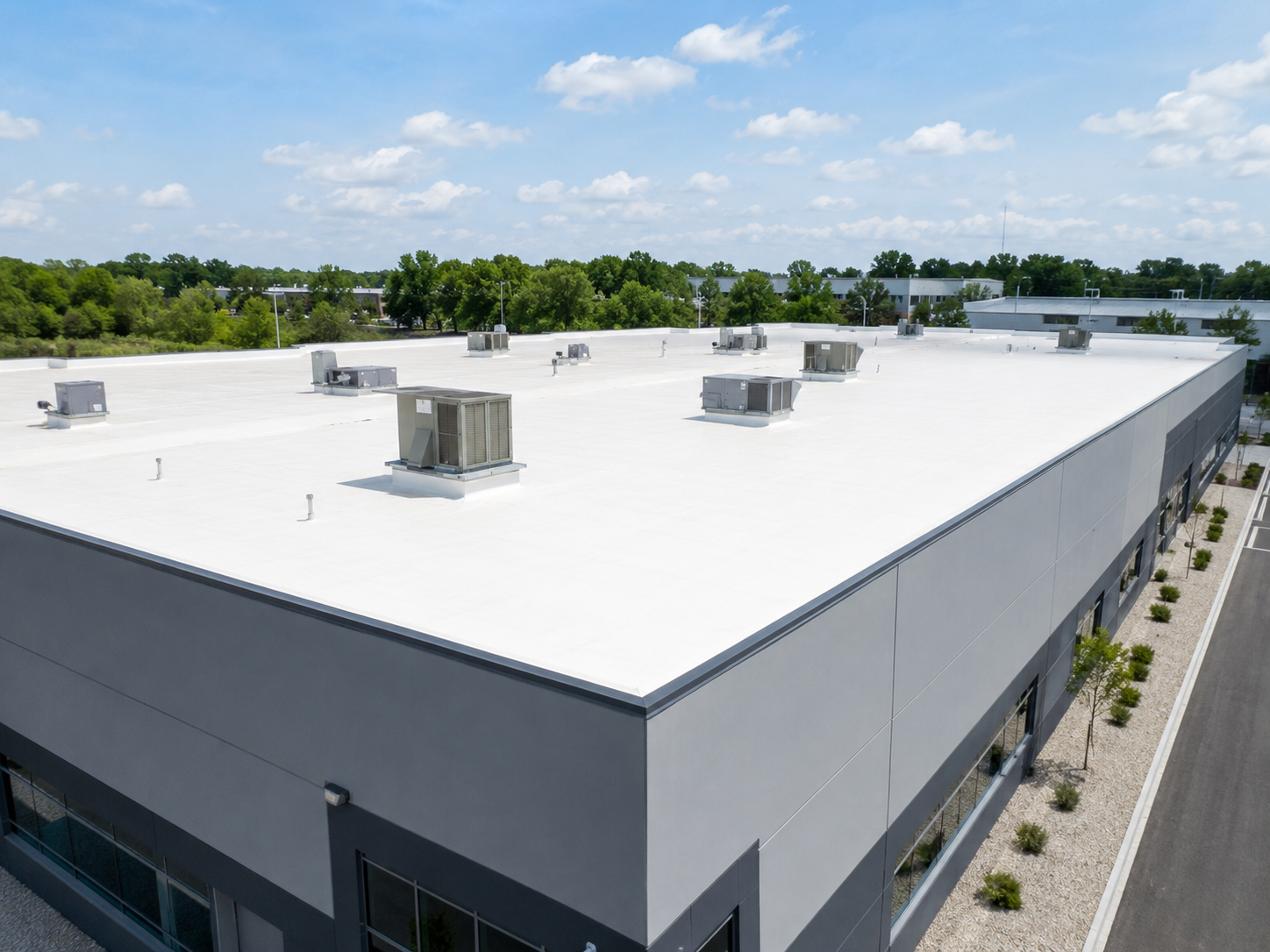 Large commercial building with a clean white flat roofing system